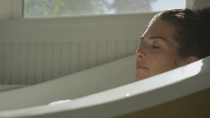 Girl laying in a bubble bath