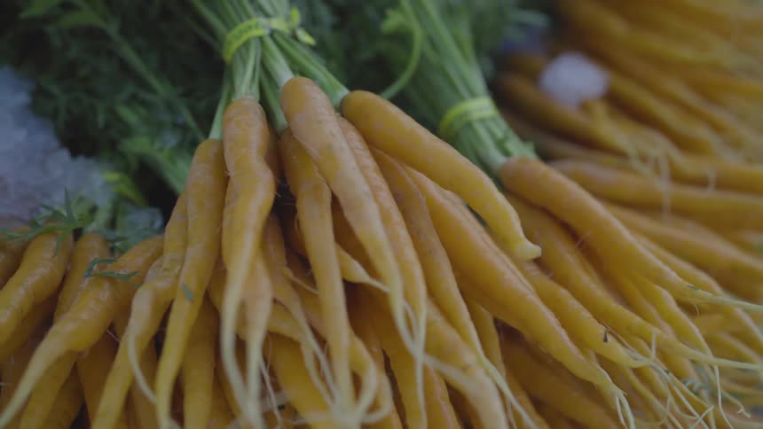 The carrots are tied together on the ice