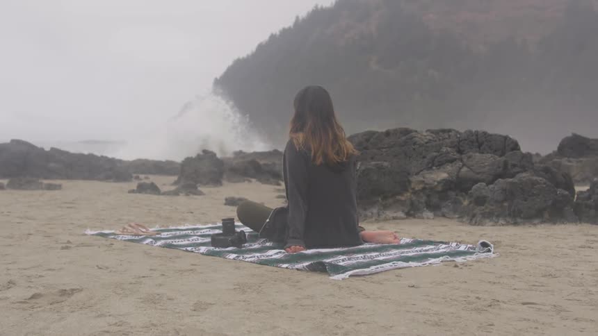 Girl sitting on the beach