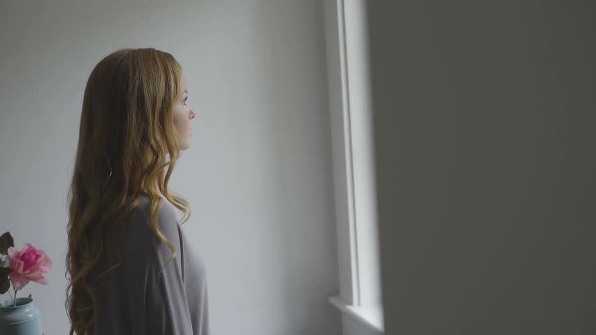 A woman looking out a window