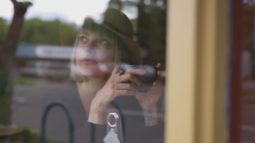 A woman drinking from a mug inside a shop