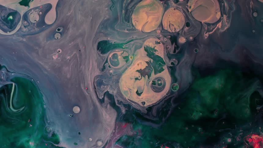 Several different colored substances slowly mix