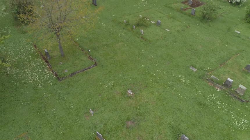 The camera flies over a cemetery