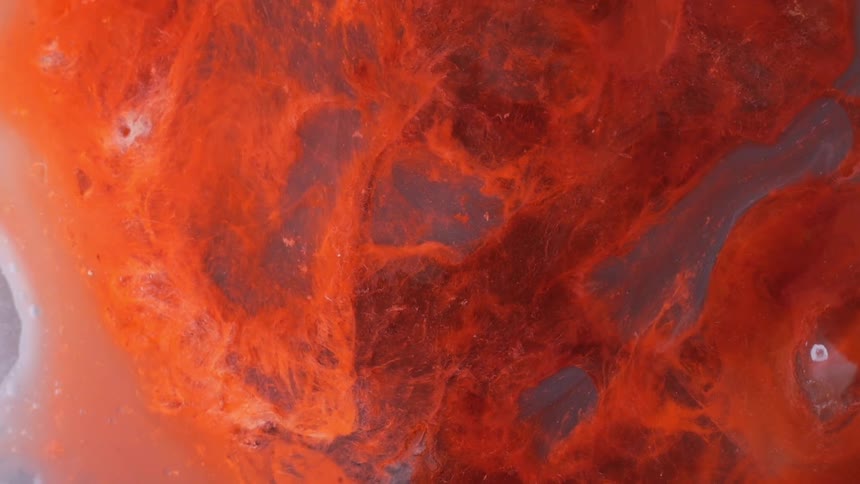Water with orange clouds of debris floating around