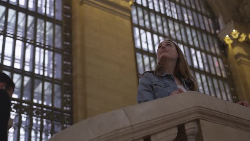 Woman looks around the interior of a building