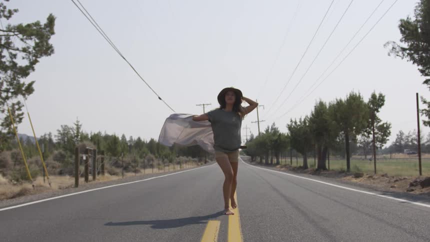 Girl running down a road