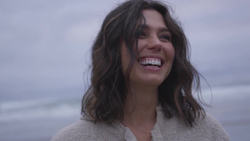 A woman laughing at something off screen