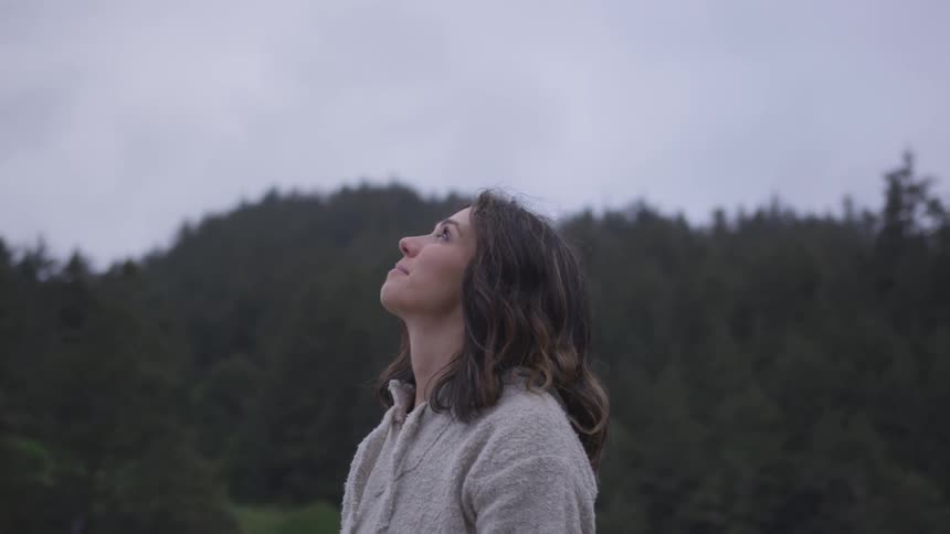 A woman stares up at the sky