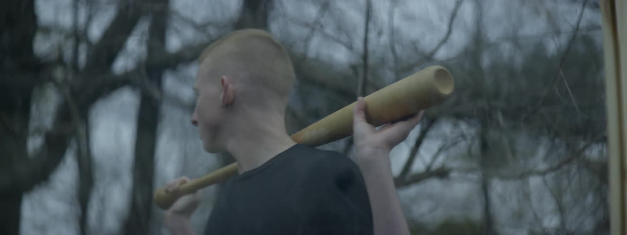 A boy debating to break a window with a bat
