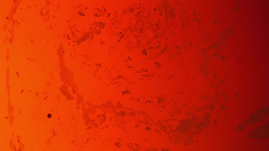 A large body of orange water with debris in it