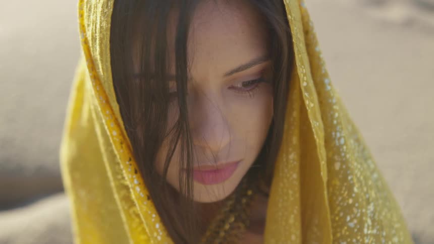 A woman wearing a sari looks over her shoulder