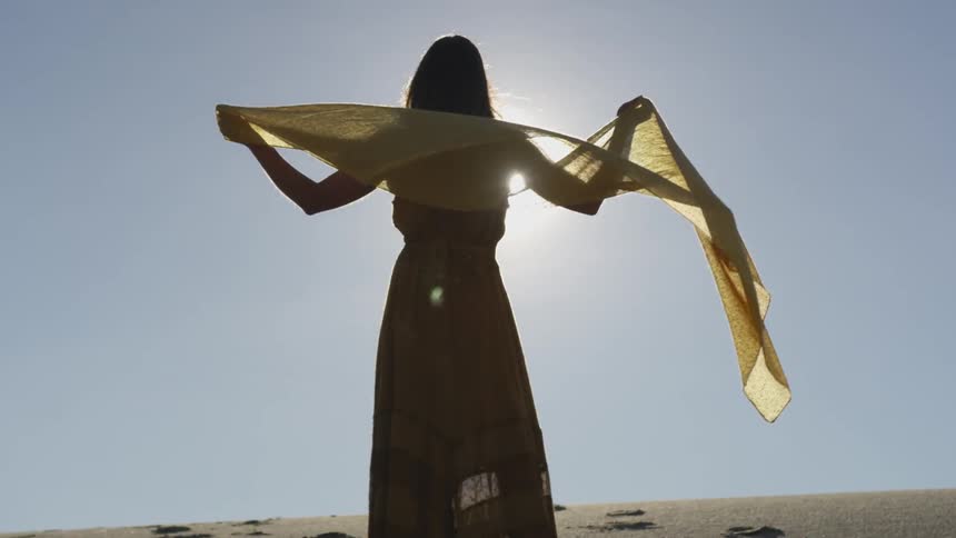 A woman posing in front of the sun