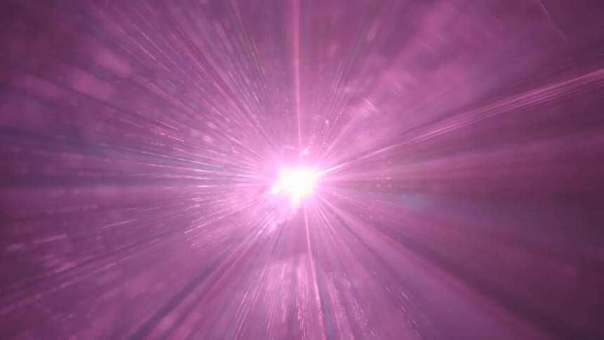 A laser light show that is flashing pink and blue