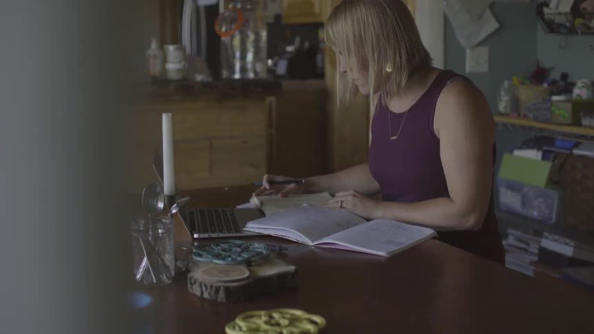 A woman working at a laptop