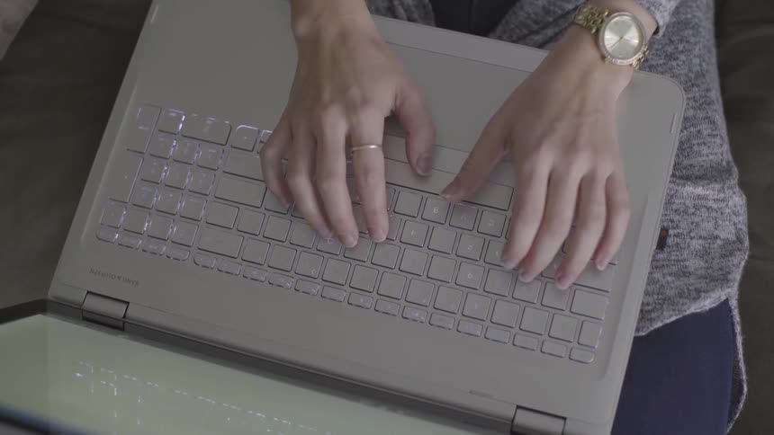 Person types on a laptop