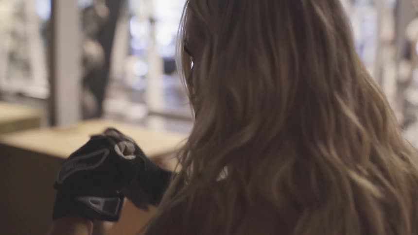 Woman with long blonde hair air boxing at the gym