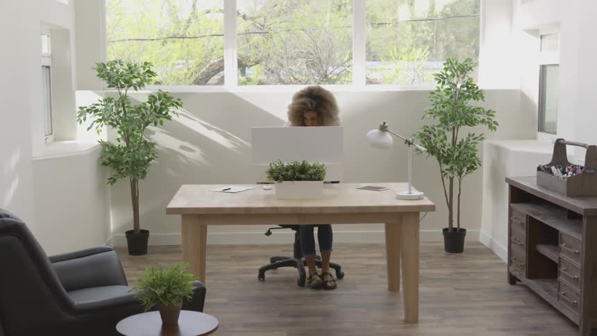 Girl walking and sitting behind a desk