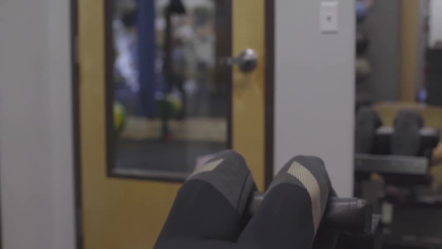 Woman does sit ups on exercise machine