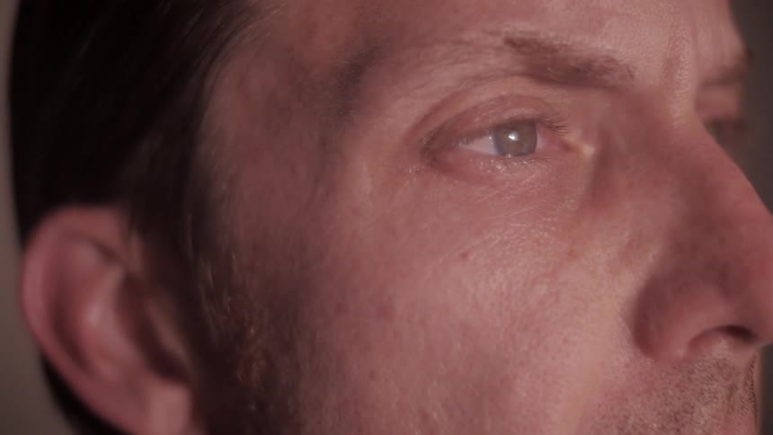 A man is shown looking at something