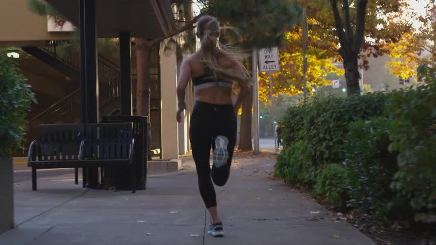 A woman is running outdoors