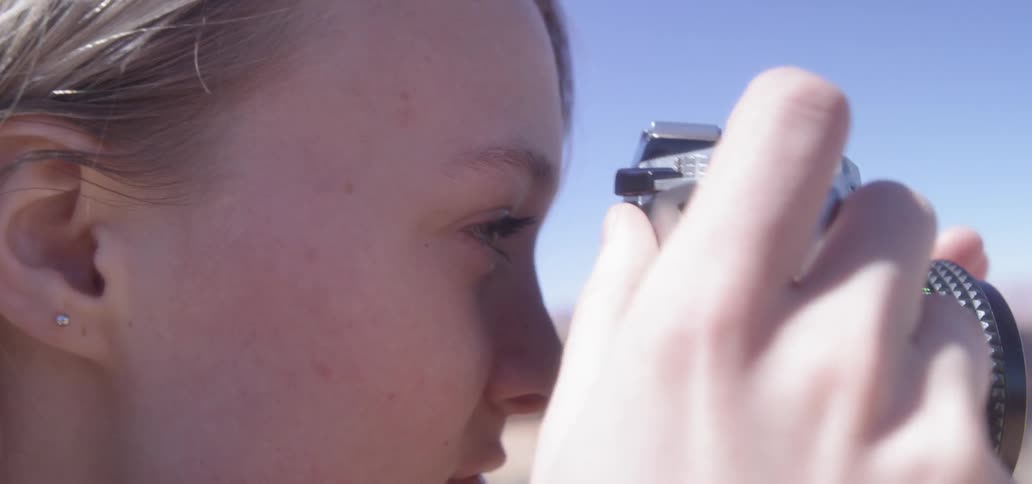 Girl looking through a camera