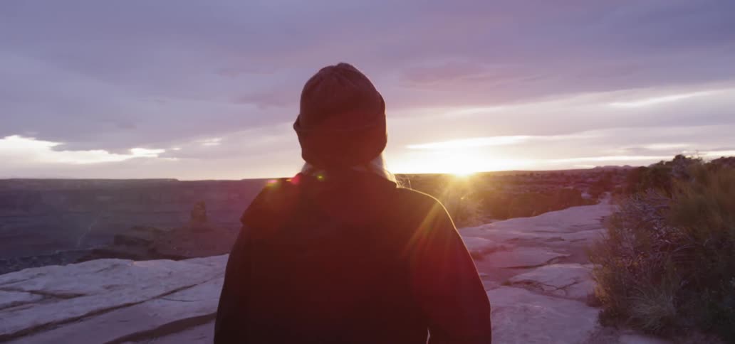 A woman walks near the cliff edge