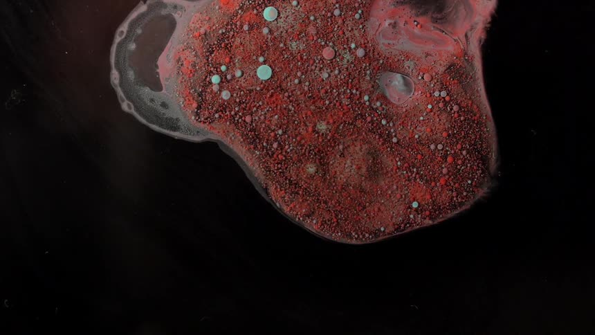 Red colored bubbling liquid substance