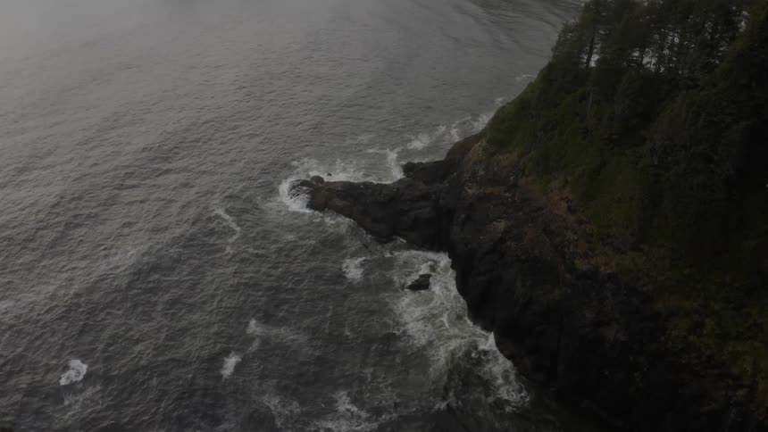 Waves crashing against a large mountain