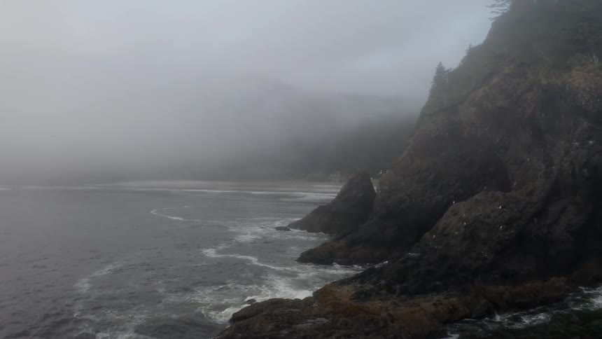 Fog over ocean near cliffs