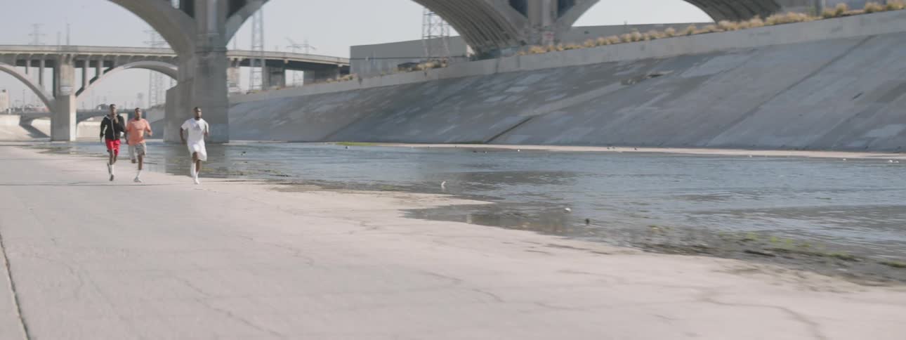 Boys running next to water