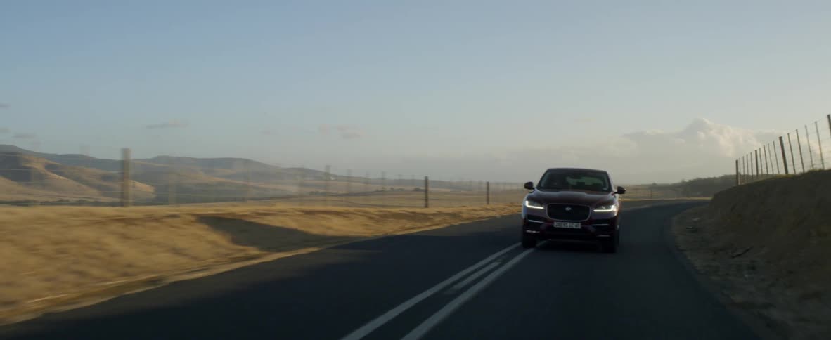Sport utility vehicle drives down center of rural highway