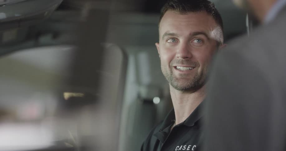 Man talking to another person while sitting in a car