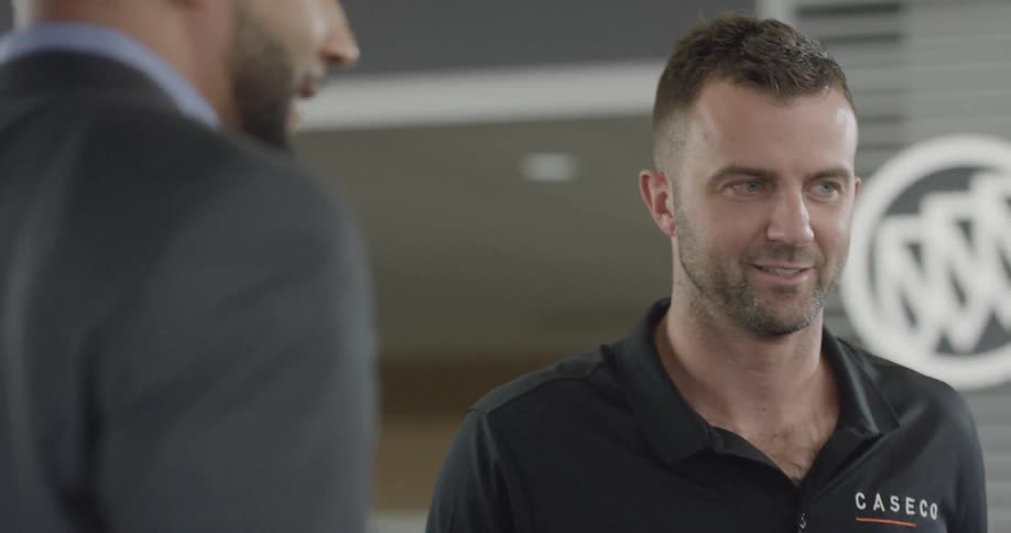 A white man speaks with a customer
