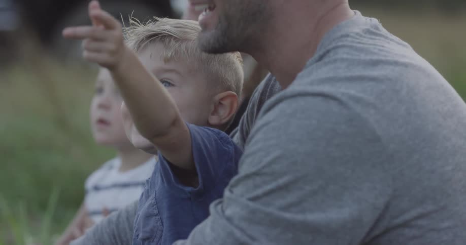 A man holds a boy on his lap