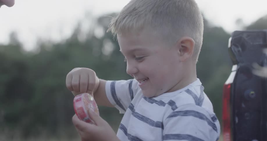A little boy holds a toy