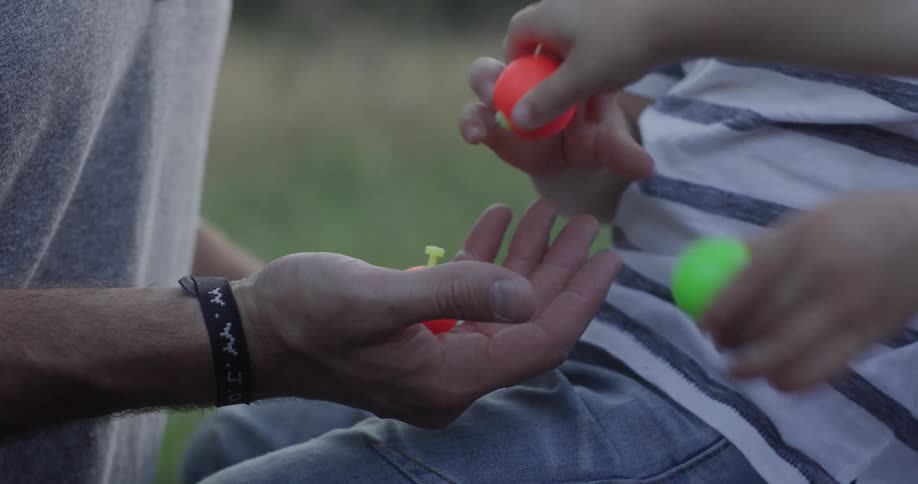 A child handing toys to a man
