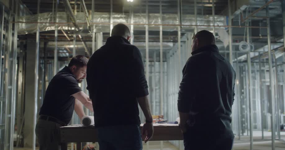 A group of men talking at a table
