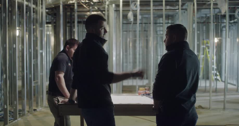 Three men talk about their surroundings