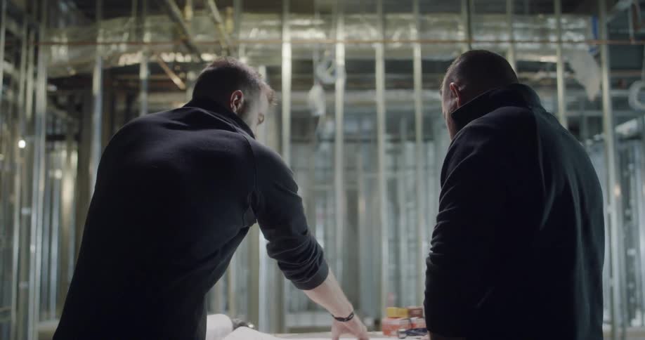 Men checking a blueprint on a construction site