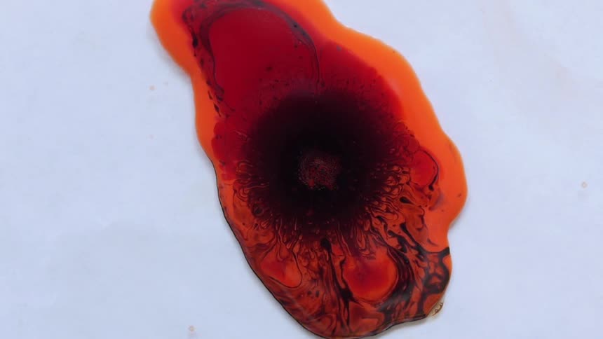 Orange water with black blobs