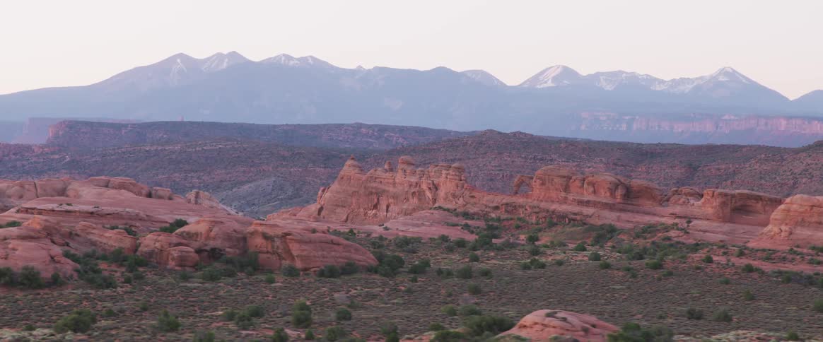 The canyons lead to mountains in the distance
