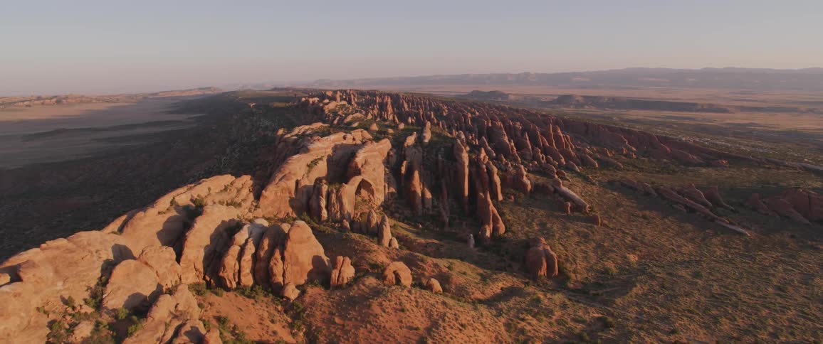 Camera flies over a desert landscape with rocks