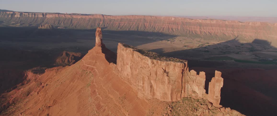 A red rocky plateau looms over the surrounding terrain