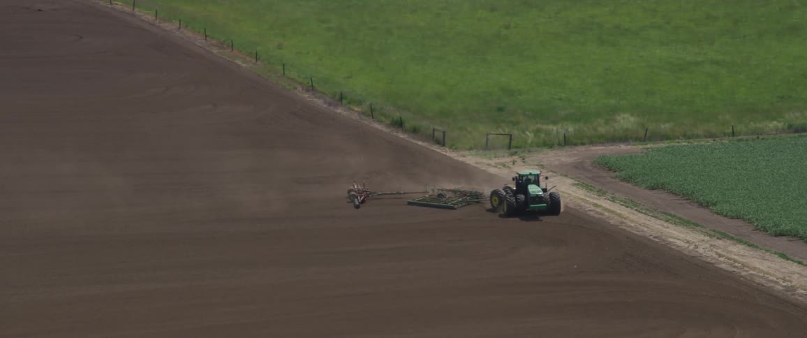 A tractor tending to a farm