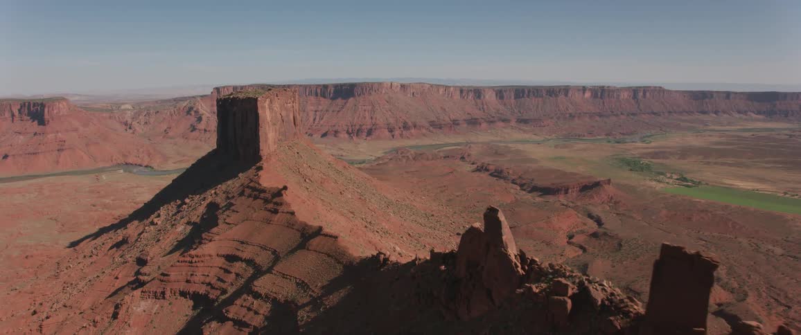 Red rock formations stand in a desert