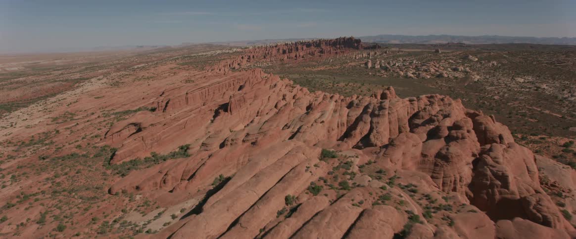 Passing over red rock formations and ridges