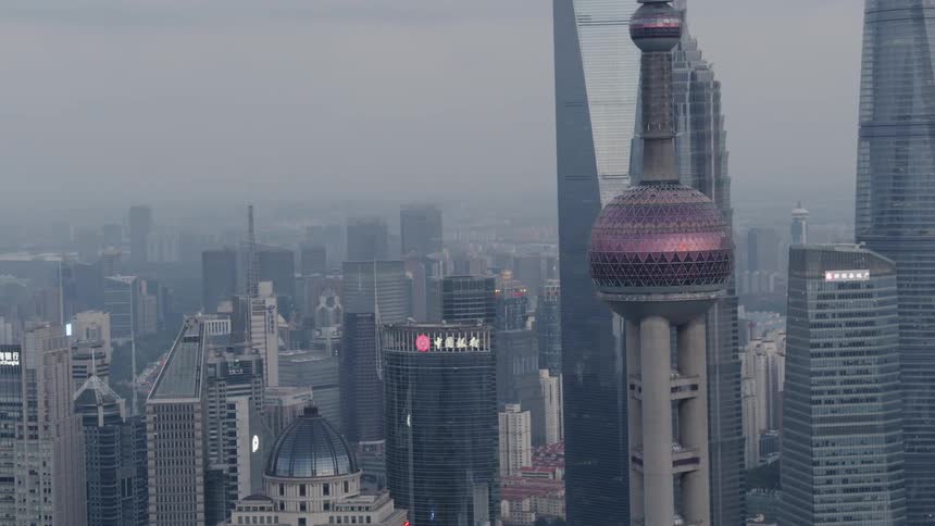 An aerial view of a large city with towering skyscrapers on a dreary day