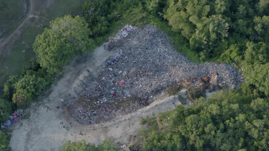 Debris and trash in pit in outdoors in the middle of the forest