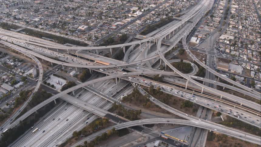 An aerial view of cars traveling on a city highway