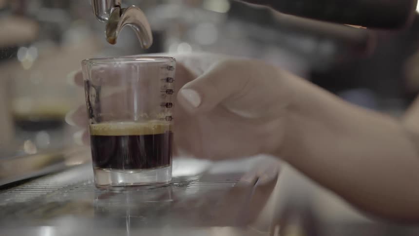 Woman takes drink and serves it at bar